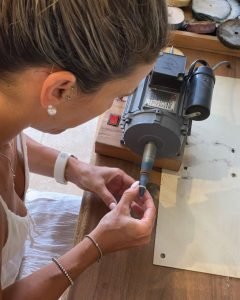 Silver workshop in progress – student polishing a ring