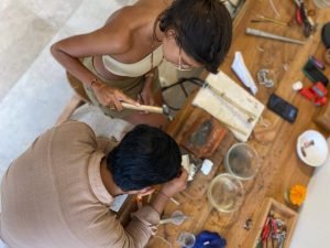 Beginner crafting her first ring with a guide at Uluwatu silver class workshop.