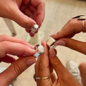 Group of friends showing off their handmade silver rings at Bingin Silver Class one of the Best Activities to Do in Seminyak for a fun and creative experience.