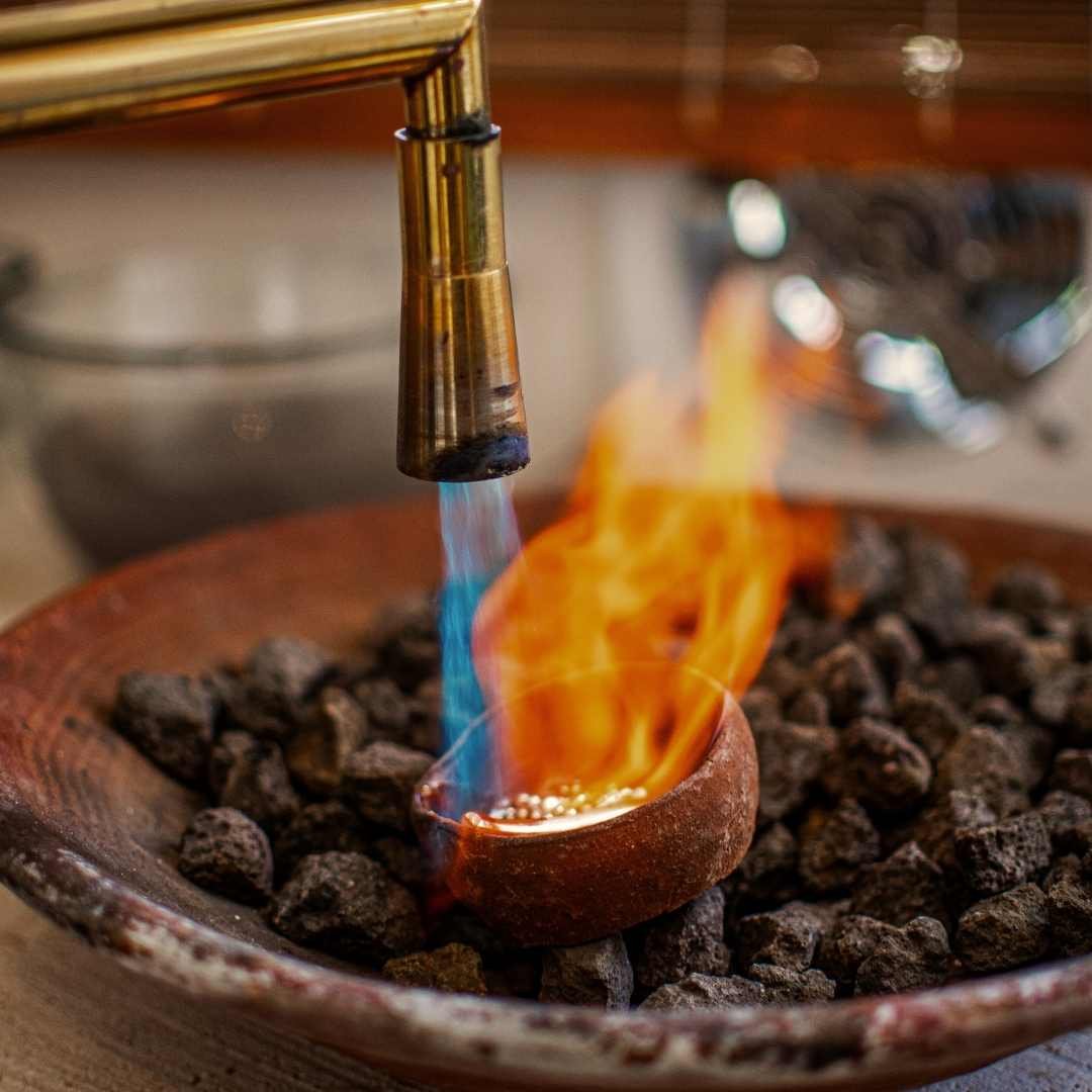 Molten silver being poured into a mold during a hands-on session at Bingin Silver Class, part of the Best Silver Jewelry Classes near Canggu for learning traditional techniques.