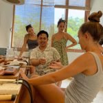 Group of travelers participating in an Uluwatu silver class, guided by a local artisan to craft unique silver jewelry pieces.