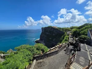 Dramatic cliffside view of Uluwatu Temple overlooking the deep blue Indian Ocean one of the Best Things to Do in Uluwatu, offering cultural charm and scenic beauty just a short ride from a peaceful Bingin silver class experience.