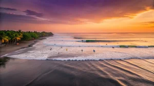 Sunset view over surfers in Canggu, Bali, highlighting the vibrant beach scene and creative activities like the Best Silver Jewelry Classes Near Canggu