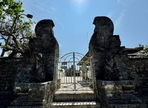 Stone gate entrance of a traditional Balinese temple, representing Bali’s rich heritage just a short drive from Seminyak’s best cultural experiences like Bingin Silver Class, one of the Best Things to Do in Uluwatu