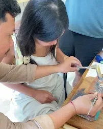 Instructor guiding tourist in Silver Jewelry Workshop Bali