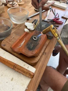 Silver jewelry making process using tools and fire at Bingin Silver Class, a unique family friendly activity in Uluwatu.