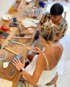 Tourists and local artisans creating jewelry together at Bingin Silver Class, one of the best family friendly activities Uluwatu offers.