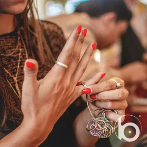 Bingin Silver Class Bali - woman trying on handmade silver rings during jewelry workshop