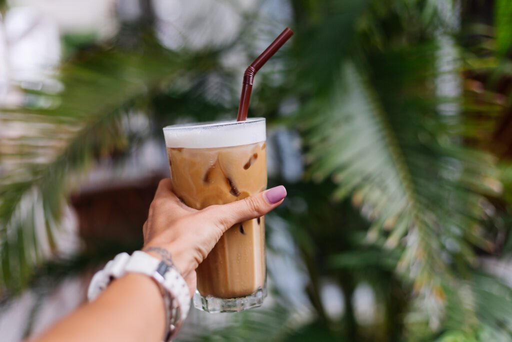 Iced coffee at a cozy café in Bingin, showing relaxing café culture as part of creative things to do in Uluwatu.