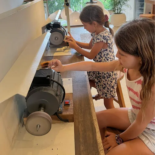 Kids and adults learning silver jewelry making Seminyak guided by local artisans.
